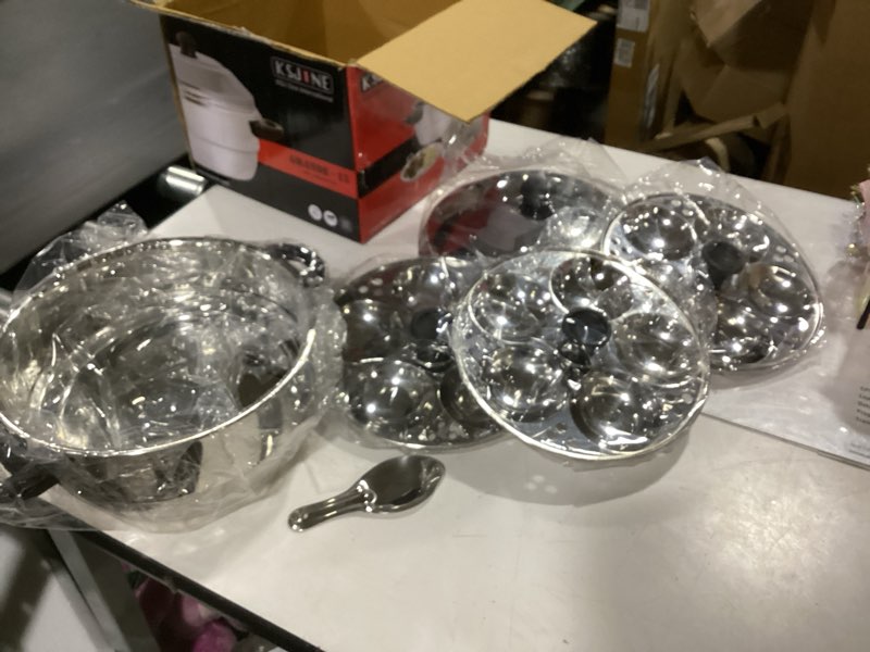Condition photo showing New/Like New for all in one idli cooker 4 pcs multi kadai with stainless steel lid, 2 idli plates (10 idlis) 1 steamer and 1 idli spoon with whistle, silver