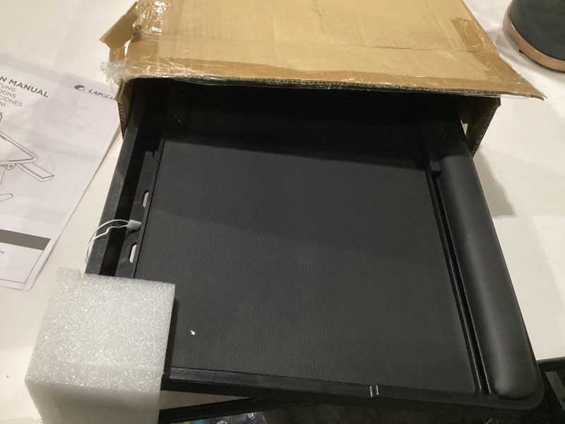 Condition photo showing As Is for lapgear easy tilt leather laptop bed desk with adjustable legs, wrist rest, media slot, and built-in storage - black - fits up to 17.3 inch laptops - style no. 78508