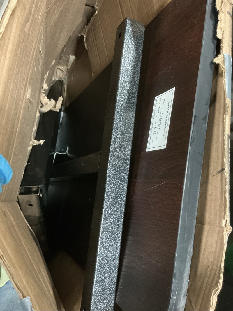 Condition photo showing As Is for drive medical overbed table with wheels - secure height adjustment for comfort - non tilt surface - smooth rolling design - home & hospital use - woodgrain laminate top - silver vein silver vein table