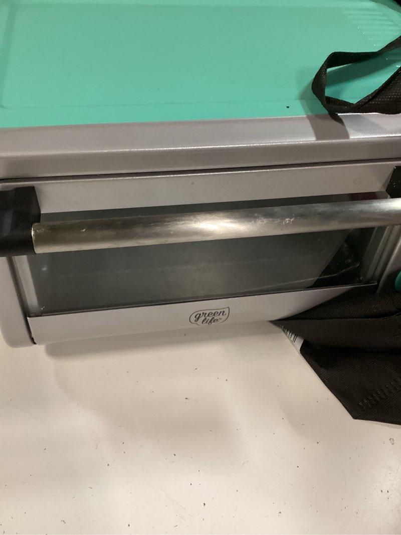 Condition photo showing As Is for greenlife countertop toaster oven air fryer stainless steel, healthy ceramic nonstick, pfas free, tray & basket, bake, broil, reheat, adjustable temp & time control, auto shutoff, turquoise countertop toaster oven air fryer turquoise