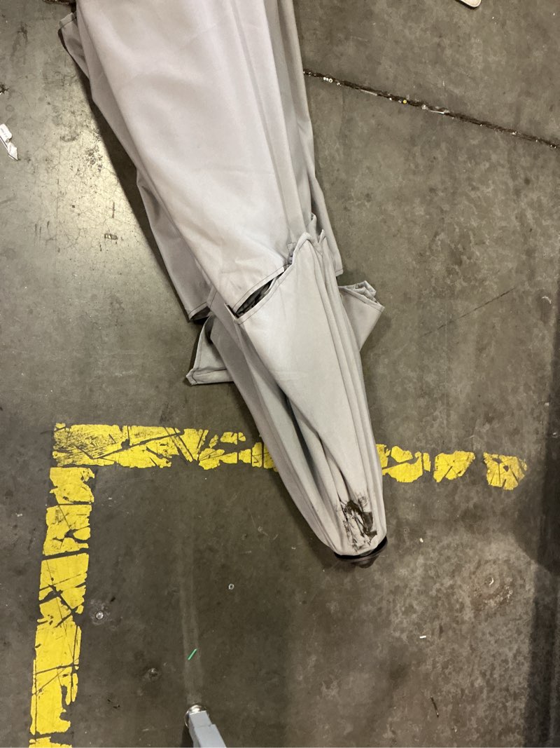 Condition photo showing As Is for gray auto-tilt market patio umbrella