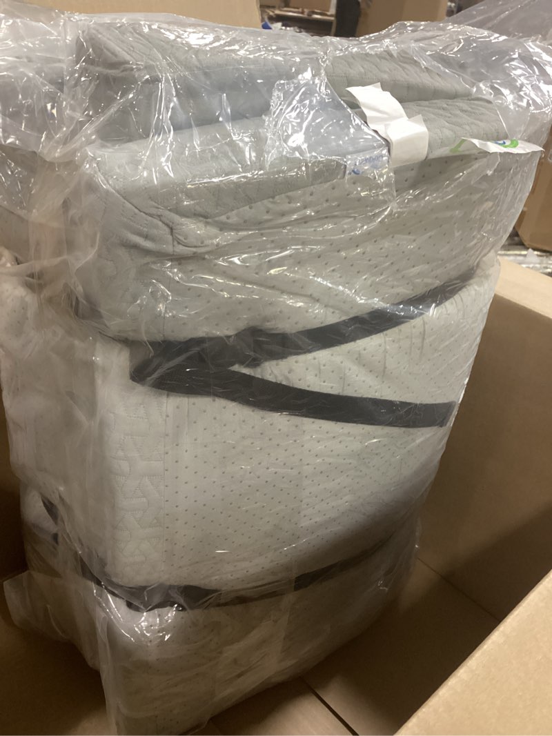  a gray quilted foam bedding item, possibly a mattress or mattress topper, packaged in plastic