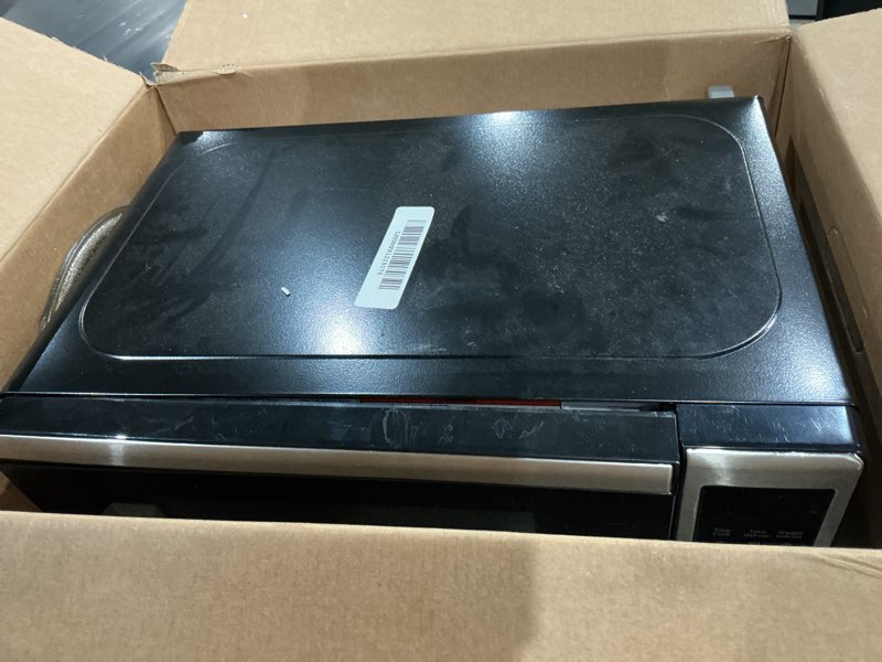 Condition photo showing As Is for black+decker em720cb7 digital microwave oven with turntable push-button door, child safety lock, 700w, stainless steel, 0.7 cu.ft 0.7 cu. ft.