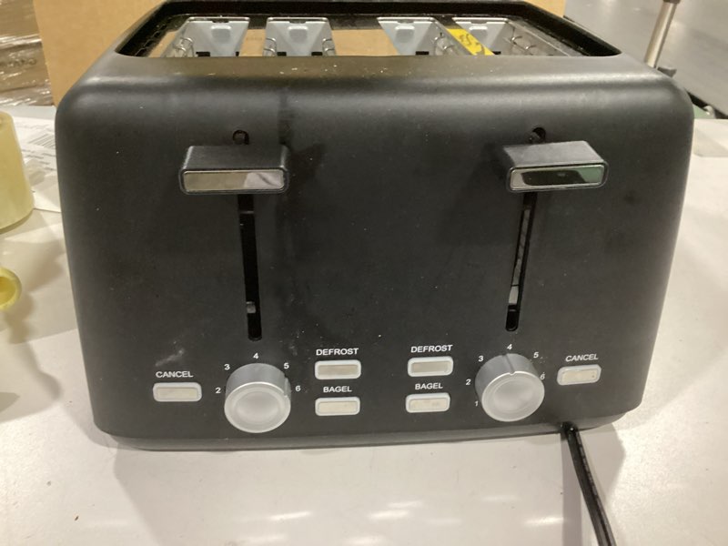 Condition photo showing As Is for Amazon Basics 4 Slice Toaster, With 7 Browning Settings, Extra Wide Slots For Bagels and Special Breads, Removable Easy-to-Clean Crumb Trays, Cancel/Defrost/Bagel Buttons, 1500W, Black & Silver 4 Slice Matte Black Front