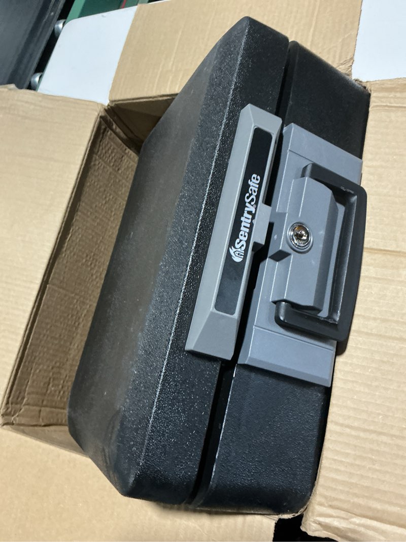 Condition photo showing As Is for sentrysafe fireproof safe box with key lock, chest safe with carrying handle to secure money, jewelry, documents, 0.25 cubic feet, 6.3 x 15.3 x 12.1 inches, 1160 fire resistant box 0.25 cu. ft.
