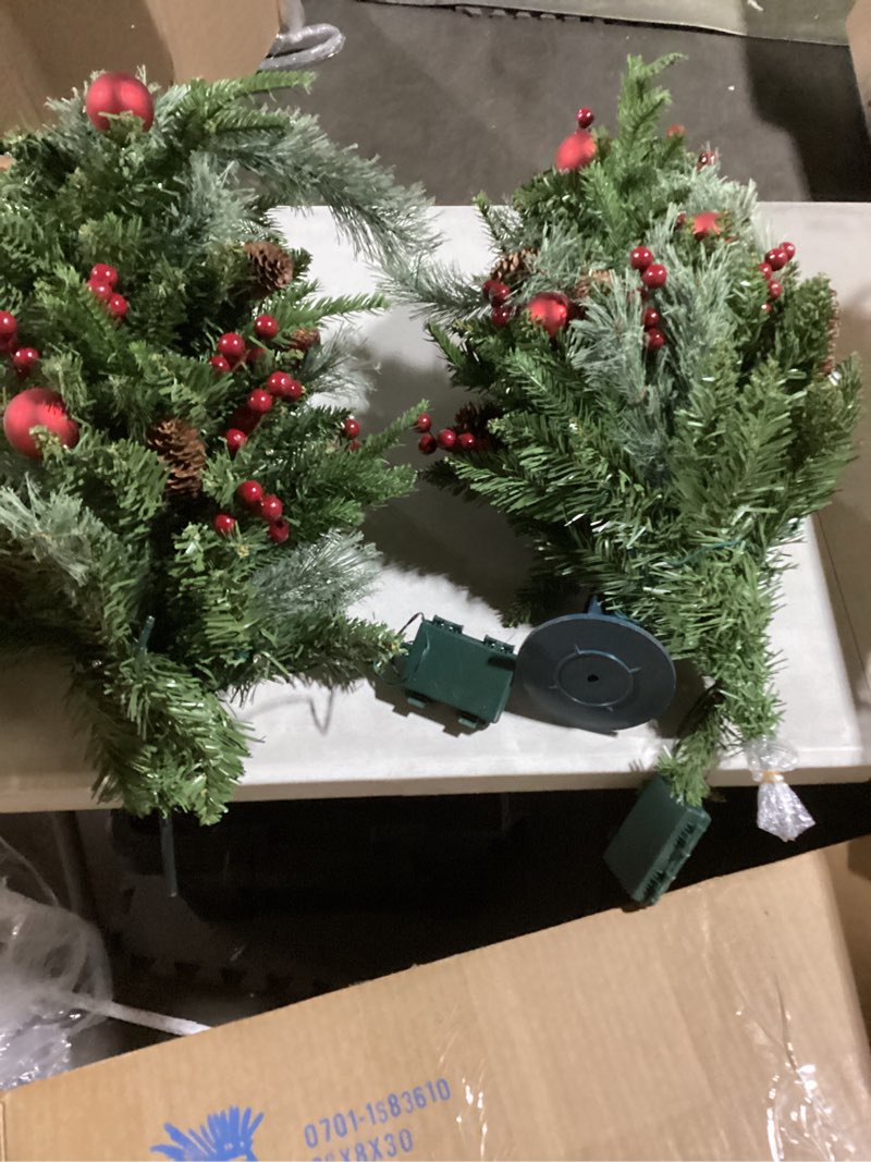 Two christmas tree decorations with lights