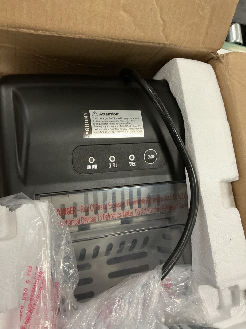 Condition photo showing As Is for EUHOMY Countertop Ice Maker Machine with Handle, 26lbs in 24Hrs, 9 Ice Cubes Ready in 6 Mins, Auto-Cleaning Portable Ice Maker with Basket and Scoop, for Home/Kitchen/Camping/RV. (Black) ICE MACHINE 11.57"D x 11.42"W x 8.74"H Black