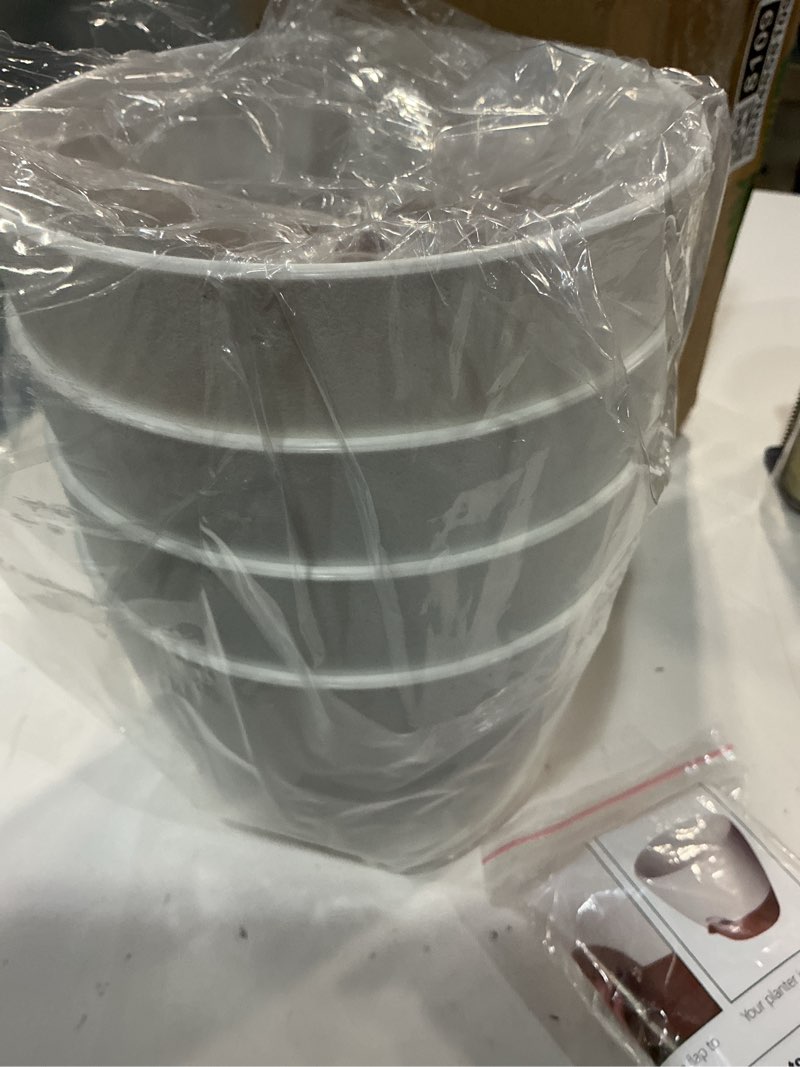 Condition photo showing Good Condition for uouz 12inch 4pack large self watering planters, plastic plant pots with 60oz removable deep reservoir and multi mesh drainage holes for indoor outdoor garden plants and flowers, white with brown