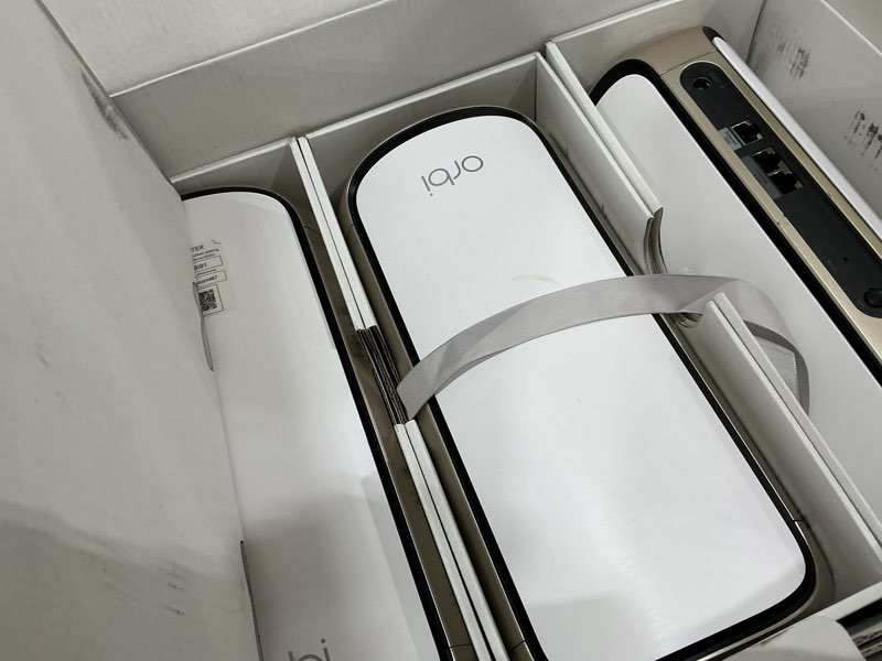 Condition photo showing As Is for netgear orbi 970 series quad-band wifi 7 mesh network system (rbe973s), router + 2 satellite extenders, security features, up to 27gbps, covers up to 10,000 sq. ft., 200 devices, 10 gig internet port 3-pack, up to 10,000 sq. ft.