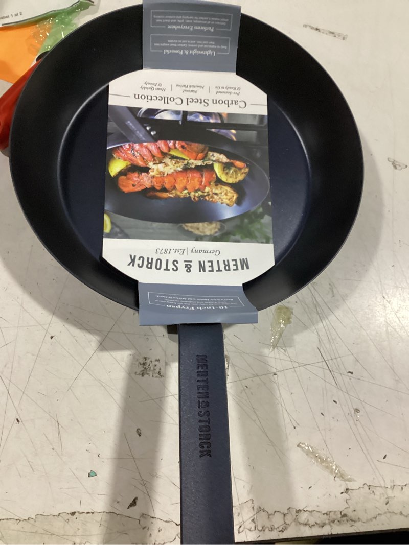 Condition photo showing New/Like New for merten & storck pre-seasoned carbon steel 10” frying pan skillet, use on induction, stove and grill, durable, even-heating, for searing, grilling, oven use, and campfire, indoor/outdoor 10" frying pan skillet black