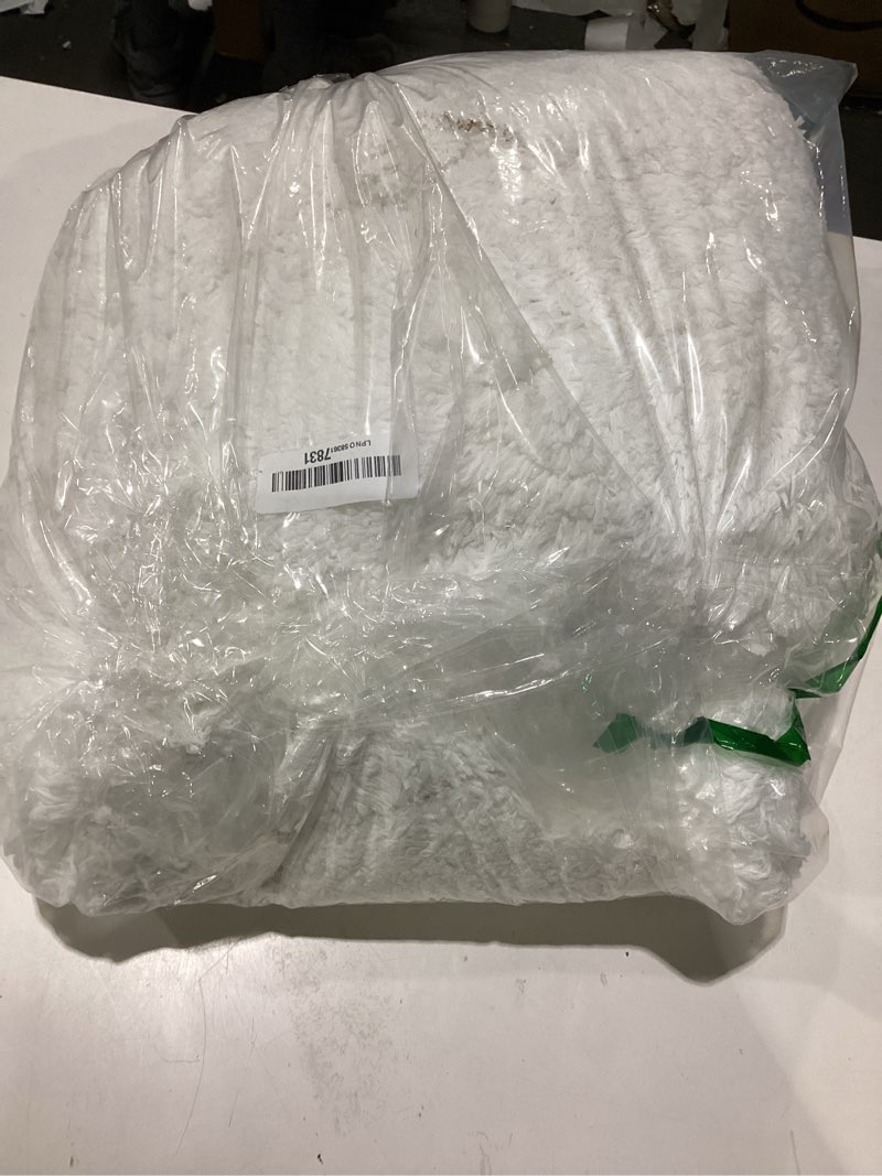 Condition photo showing As Is for fuzzy white rug small