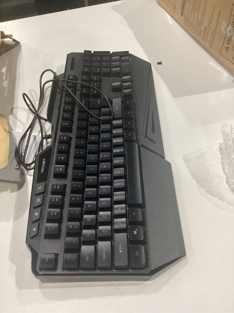 Condition photo showing As Is for tecknet wired rgb gaming keyboard - 26-key anti-ghosting, 13 lighting modes, spill-resistant, 108 membrane keys, plug & play - with ergonomic wrist rest & phone holder for windows/mac (black)