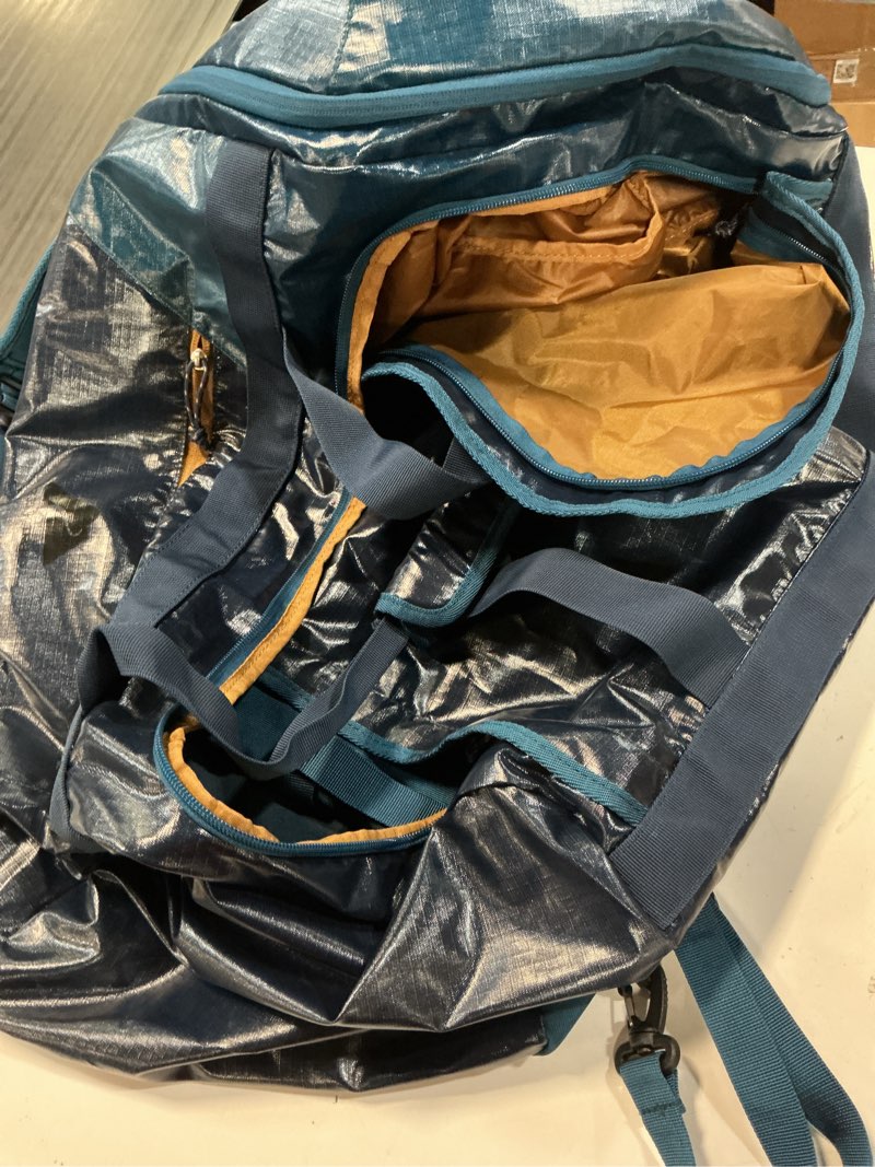 Condition photo showing Good Condition for ozark trail 70 ltr coated polyester ripstop duffel, with tuckable backpack straps, blue