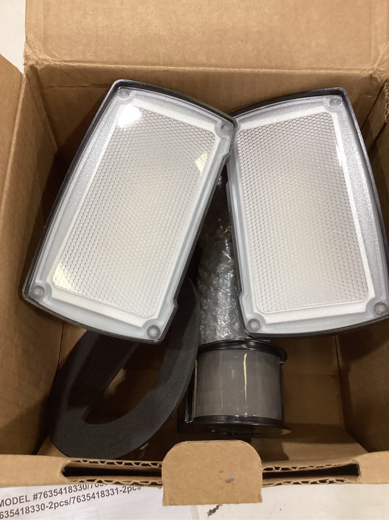 Condition photo showing As Is for ume 19w led flood light motion sensor outdoor, 2 adjustable head, 2000lm, 5000k, ip65 waterproof, dusk to dawn security light with photocell for exterior,outside,garage,house(black) 1pack black