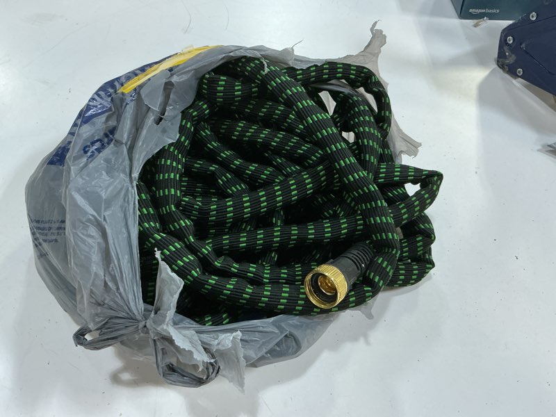 Condition photo showing As Is for flexi hose expandable garden hose with 8 function nozzle, 100ft - lightweight retractable garden hose, water hose - no-kink flexibility, 3/4 inch solid brass fittings and double latex core