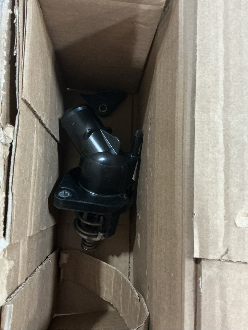 Condition photo showing As Is for gm genuine parts 15-11113 (12674634) water pump outlet assembly with thermostat