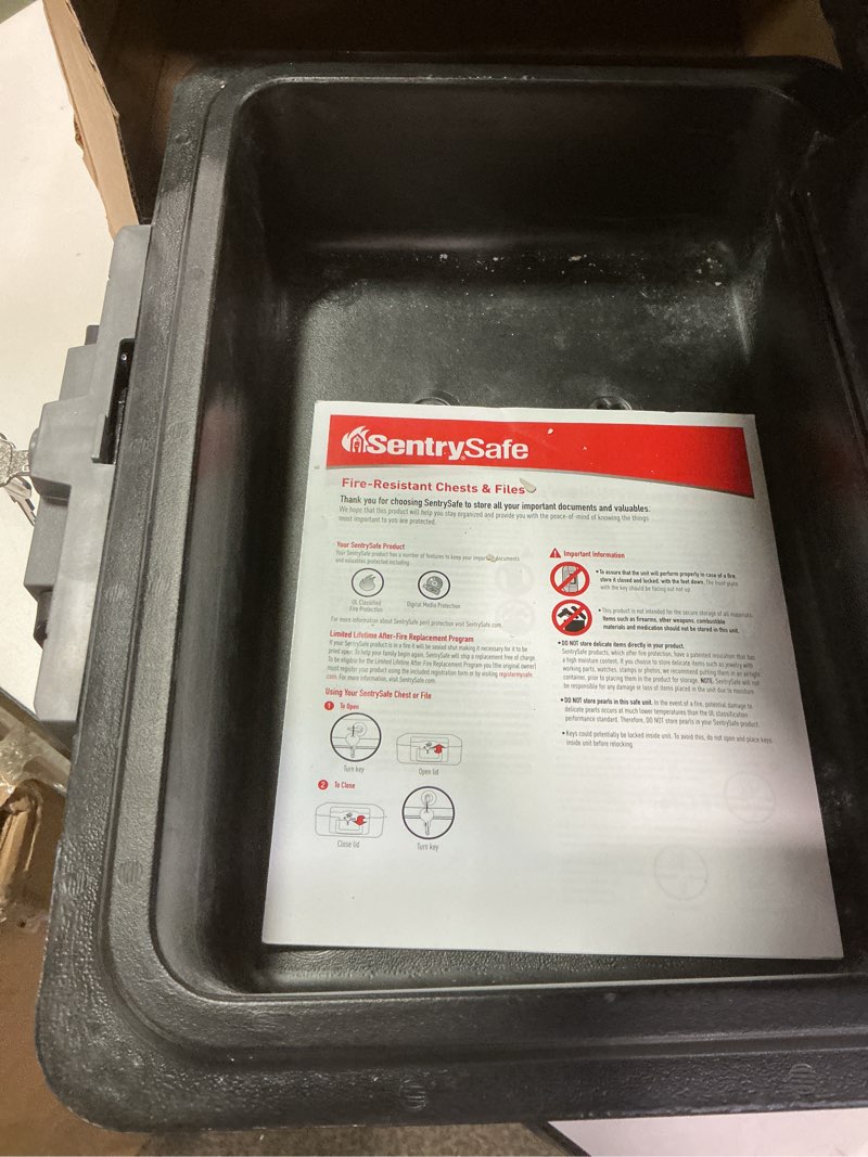 Condition photo showing As Is for SentrySafe Fireproof Safe Box with Key Lock, Chest Safe with Carrying Handle to Secure Money, Jewelry, Documents, 0.25 Cubic Feet, 6.3 x 15.3 x 12.1 Inches, 1160 Fire resistant box 0.25 cu. ft.