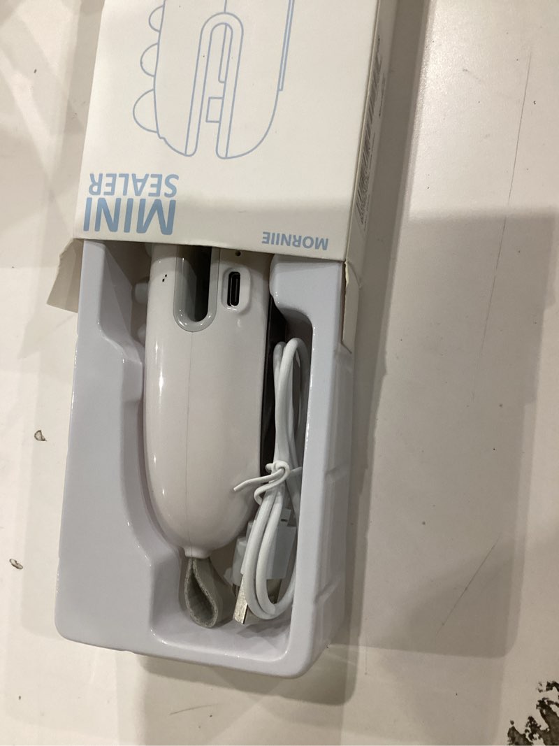 Condition photo showing As Is for Mini Bag Sealer with Cutter, Rechargeable, Handheld Heat Sealer Machine with Magnetic, Portable Bag Sealer Heat Seal for Keep Food Fresh and Snacks Crispy. White