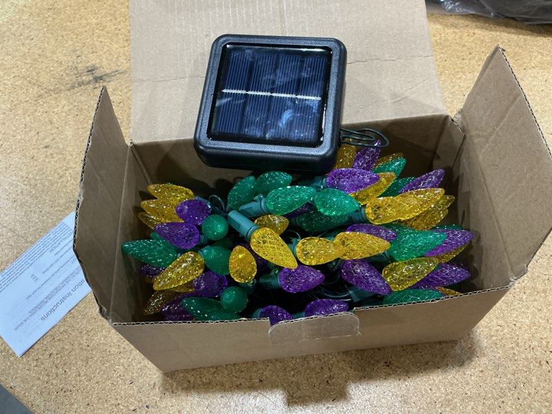 Condition photo showing Good Condition for reyeeinc solar mardi gras lights, solar powered outdoor waterproof string lights with 39ft 100 count c6 strawberry lights and 8 modes for outside mardi gras tree carnival porch fence party decors yellow, green, purple