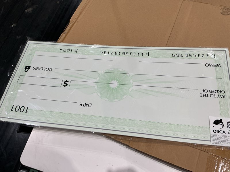 Condition photo showing New/Like New for orca giant check — thick reusable dry erase check for presentations  awards  prizes  fundraisers  donations  endowments (36 x16 )