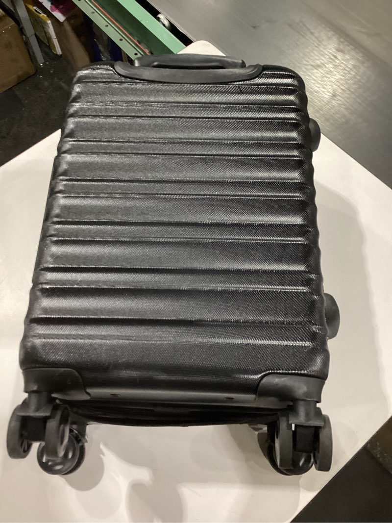 Condition photo showing As Is for Amazon Basics 21" Hardside Carry-On Luggage, Hardshell Suitcase With Wheels, Expandable For Up to 25% More Space, With Scratch-Resistant Surface, Four Multi-directional Wheels, Black Black Carry-On