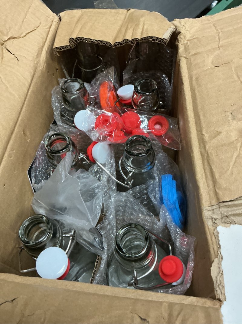 Condition photo showing Good Condition for 8 pack [1 l / 33 fl. oz.] swing top glass bottles w/ airtight stopper lids – flip top brewing bottle for fermentation, kombucha, mead, vinegar, beer, kefir, wine, soda – with 8 extra seals & 2 pourer