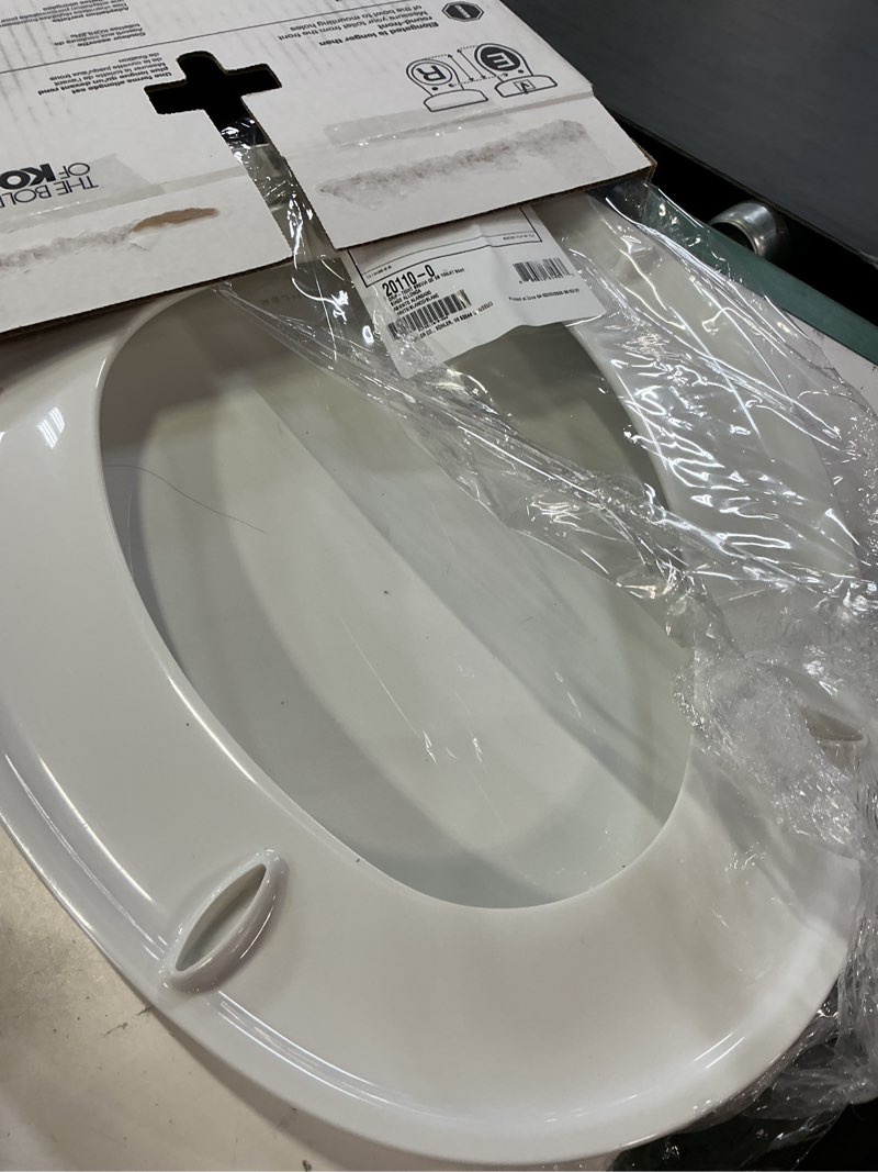 Condition photo showing As Is for kohler 20110-0 brevia, slow close toilet seat, elongated toilet seat, grip-tight bumpers quick-attach hardware, white white elongated quiet-close