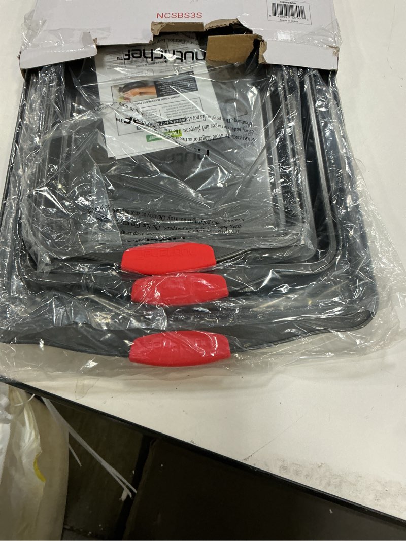 Condition photo showing Good Condition for NutriChef 3-Piece Nonstick Kitchen Oven Baking Pans - Premium & Stylish Non-Stick Steel, Commercial Grade Restaurant Quality Metal Bakeware with Red Silicone Handles - Easy to Clean, NCSBS3S 3-Piece Set