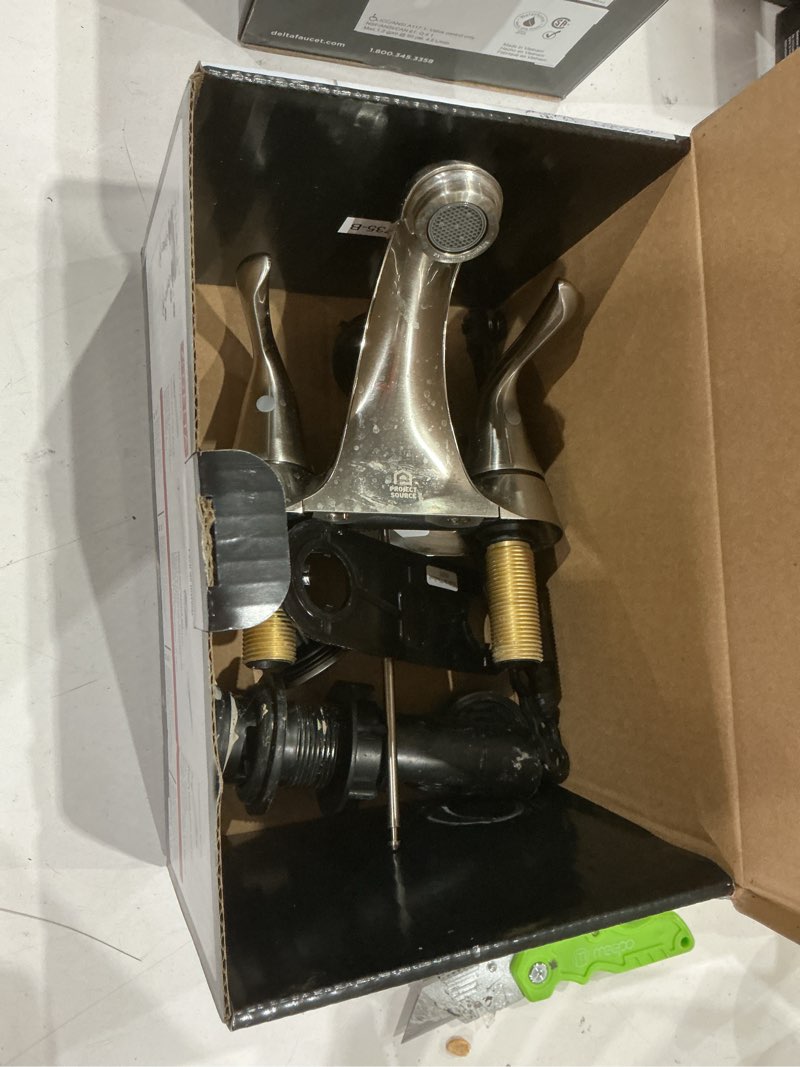 Condition photo showing As Is for delta foundations brushed nickel 4-in centerset 2-handle watersense bathroom sink faucet with drain