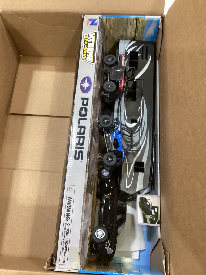 Condition photo showing Good Condition for new ray toys die cast pick up truck with toy hauler and 2 polaris vehicles (blue rzr and red ranger)