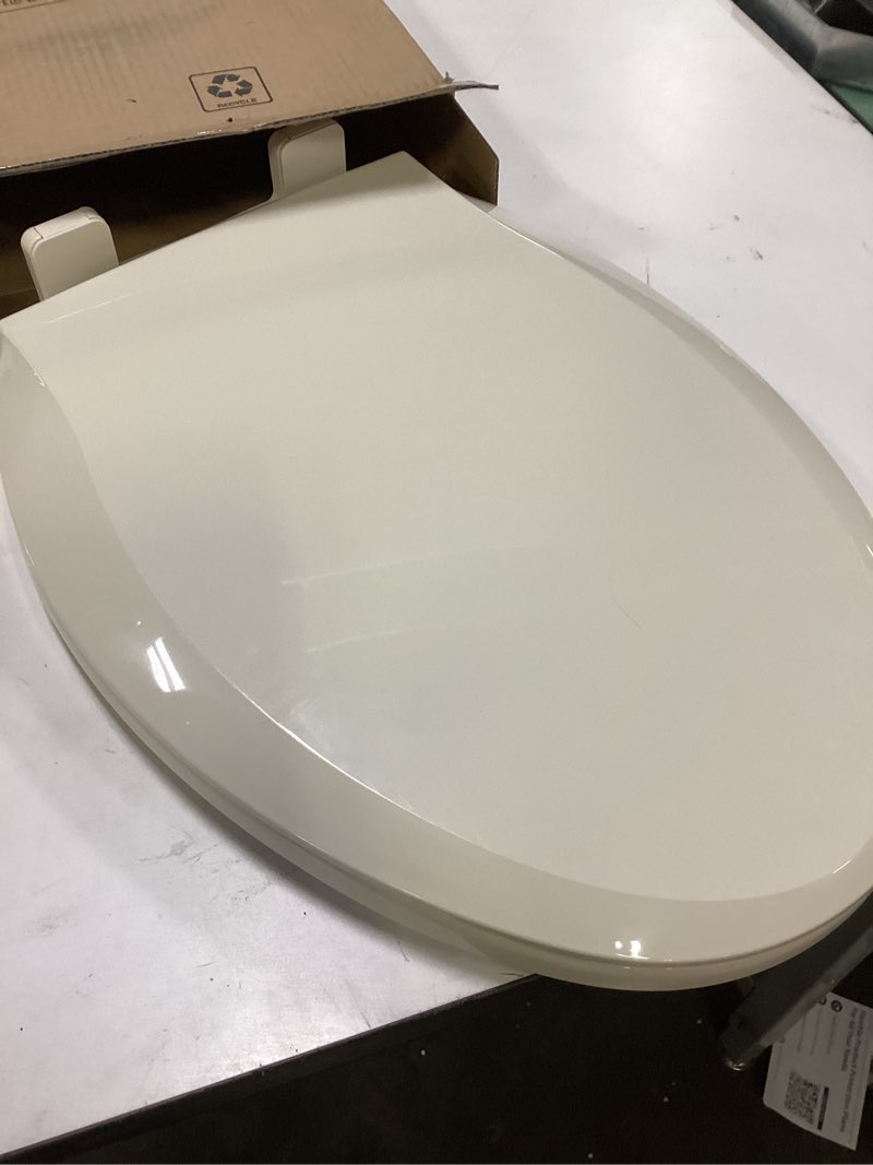 Condition photo showing Good Condition for Bemis Elongated Enameled Wood Toilet Seat in Biscuit with Easy•Clean? Hinge
