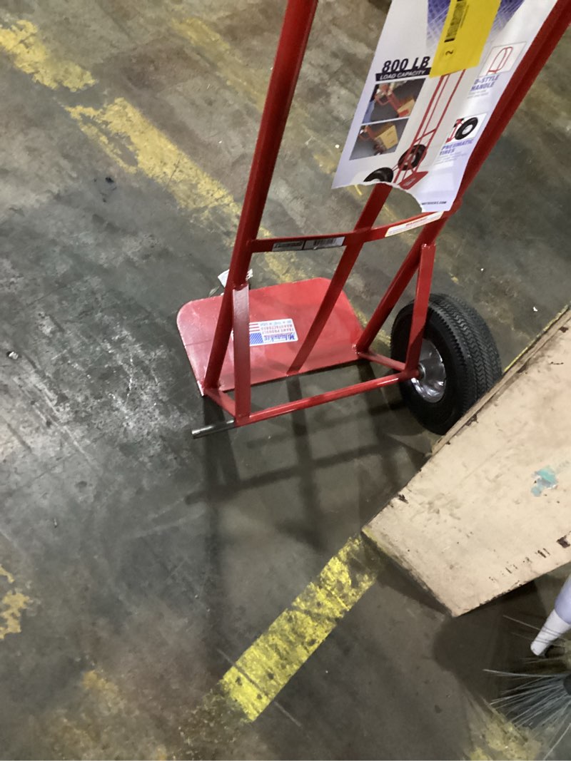 Condition photo showing As Is for similar to stock photo .. missing parts.. goplus hand truck, p-handle hand truck dolly w/770lbs capacity, vertical loop handle, 10” rubber wheels, 14.5”x 8.5” foldable nose plate, heavy duty metal dolly cart for lifting, stairs square handle-red