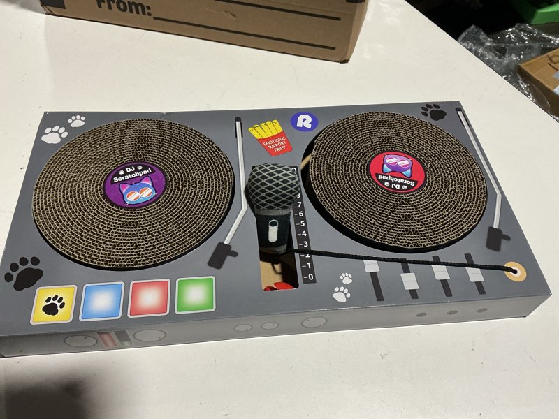Condition photo showing Good Condition for dj scratchpad by relatable, enrichment cat toys and kitten toys for your furry friends, cat tree essentials, includes box with 2 scratch wheels, 1 plastic ball with bell, and attached microphone plush