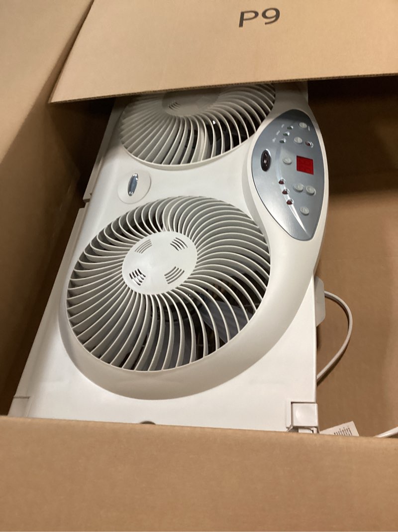 Condition photo showing As Is for Bionaire Window Fan with Reversible Airflow Blades – 3-Speed Settings, Programmable Thermostat, LED Display, Remote Control, Fits 24–36" Windows, No Assembly Required White 2 Blades Electronic control with LCD screen Window Fan