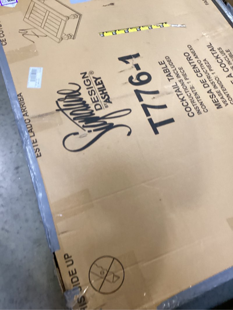 Condition photo showing New/Like New for signature design by ashley johnelle farmhouse coffee table with weathered gray finish, gray