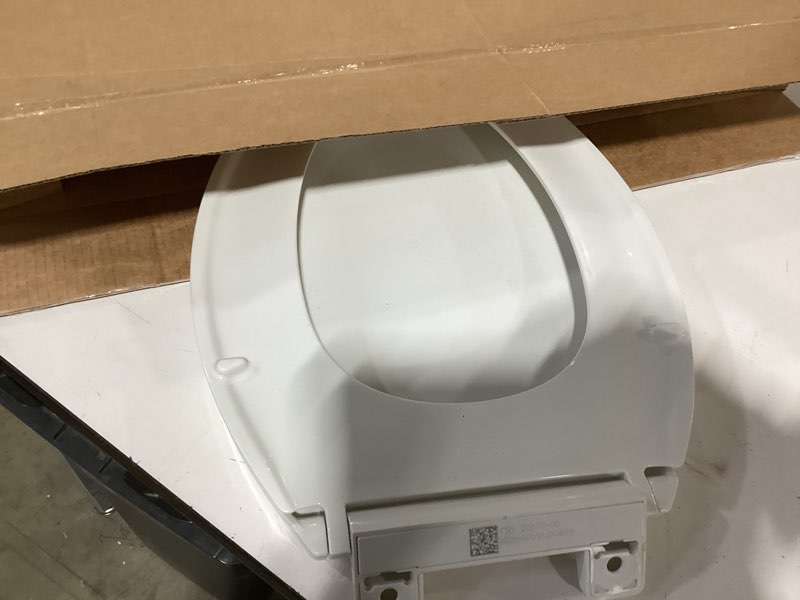 Condition photo showing As Is for kohler 20110-0 brevia, slow close toilet seat, elongated toilet seat, grip-tight bumpers quick-attach hardware, white white elongated quiet-close