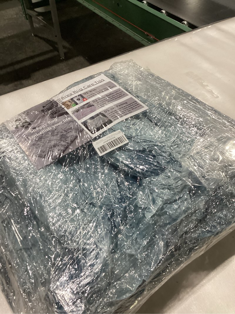 Blue shaggy area rug size unknown