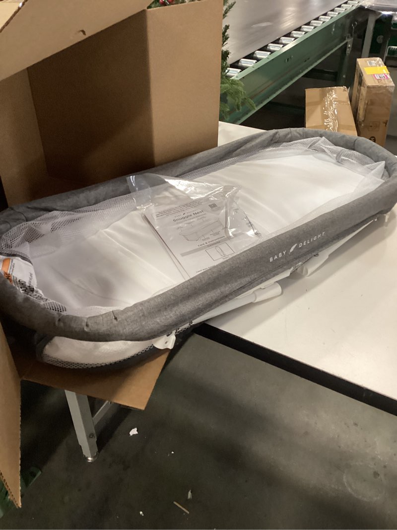 Condition photo showing As Is for Baby Delight Snuggle Nest Bassinet, Portable Baby Bed, for Infants 0 – 5 Months, Charcoal Tweed