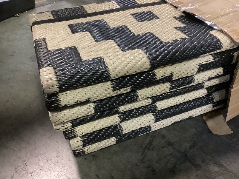 Condition photo showing New/Like New for SAND MINE Reversible Mats, Plastic Straw Rug, Modern Area Rug, Large Floor Mat and Rug for Outdoors, RV, Patio, Backyard, Deck, Picnic, Beach, Trailer, Camping, Black & Beige, 10' x 14' Black & Beige 10' x 14'