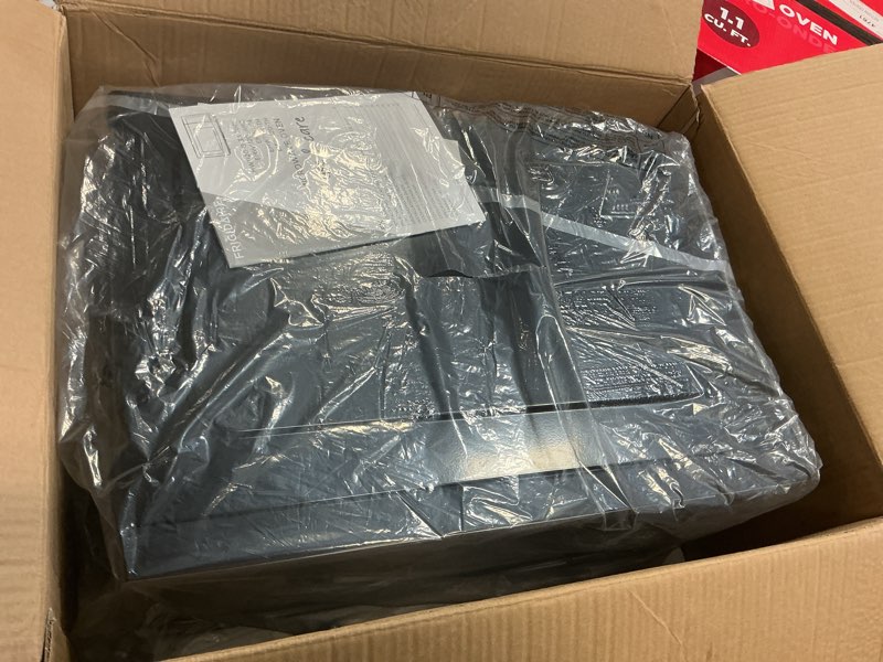 Condition photo showing As Is for Frigidaire EMW112OAMZ Stainless Steel Microwave Oven, Multi Function, Programmable, 1.1 Cu Ft 1000-Watt, residential kitchen, Stainless