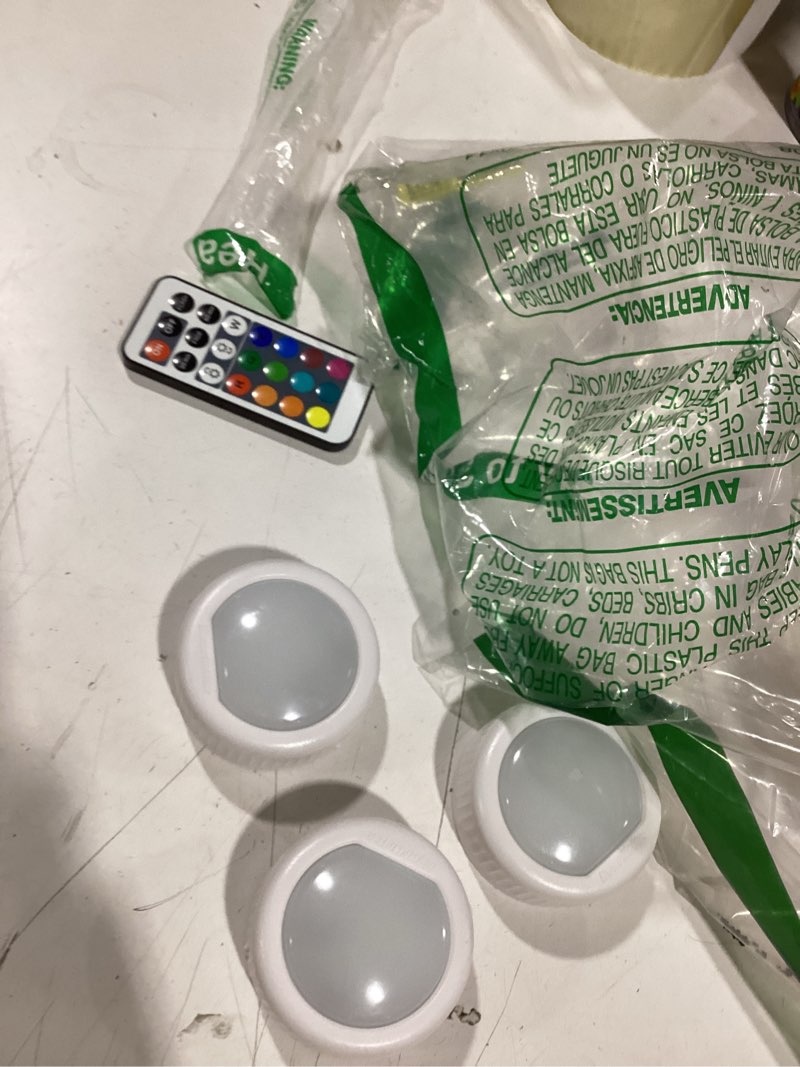 Condition photo showing As Is for similar to everbrite puck lights with remote, rechargeable 2000mah linked sensor under cabinet, two group control, 10 rgb colors, dimmable for kitchen, bedroom closet (6-pack) circle shape