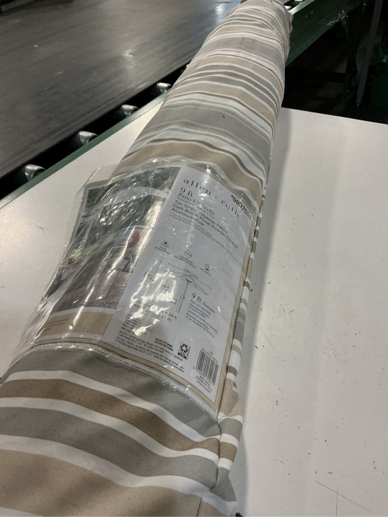 Condition photo showing As Is for allen + roth 9-ft aluminum tan auto-tilt market patio umbrella
