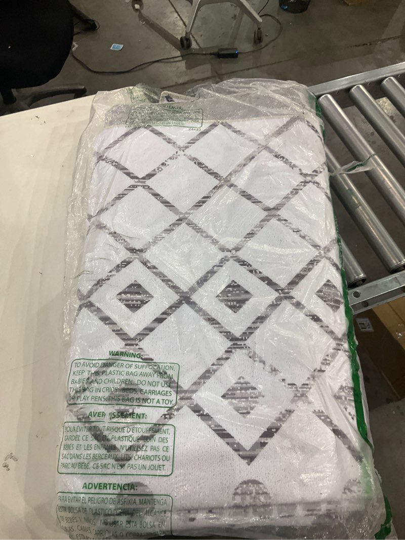 Condition photo showing As Is for Revel grey and white rug