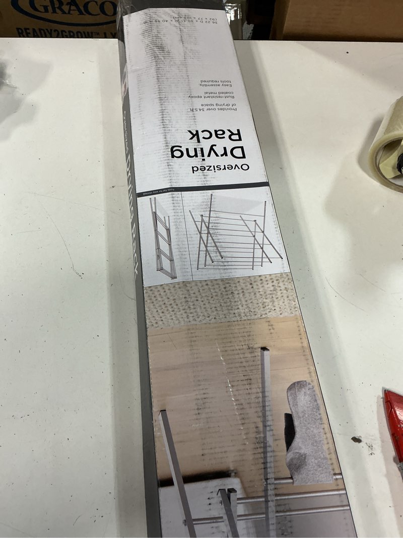 Condition photo showing As Is for whitmor oversized metal drying rack, silver