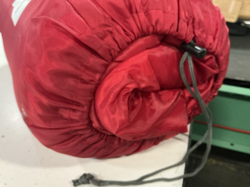 Condition photo showing As Is for ozark trail 50-degree warm weather red sleeping bag, 33"x75"