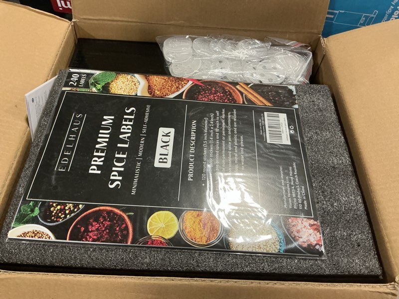 Condition photo showing New/Like New for edelhaus square glass spice jars (24 x 4oz) with black lids + magnetic spice rack for refrigerator (fits 12 jars) + bonus slim auxiliary rack, 240 labels, shaker inserts, funnel black stainless steel lid + magnetic rack