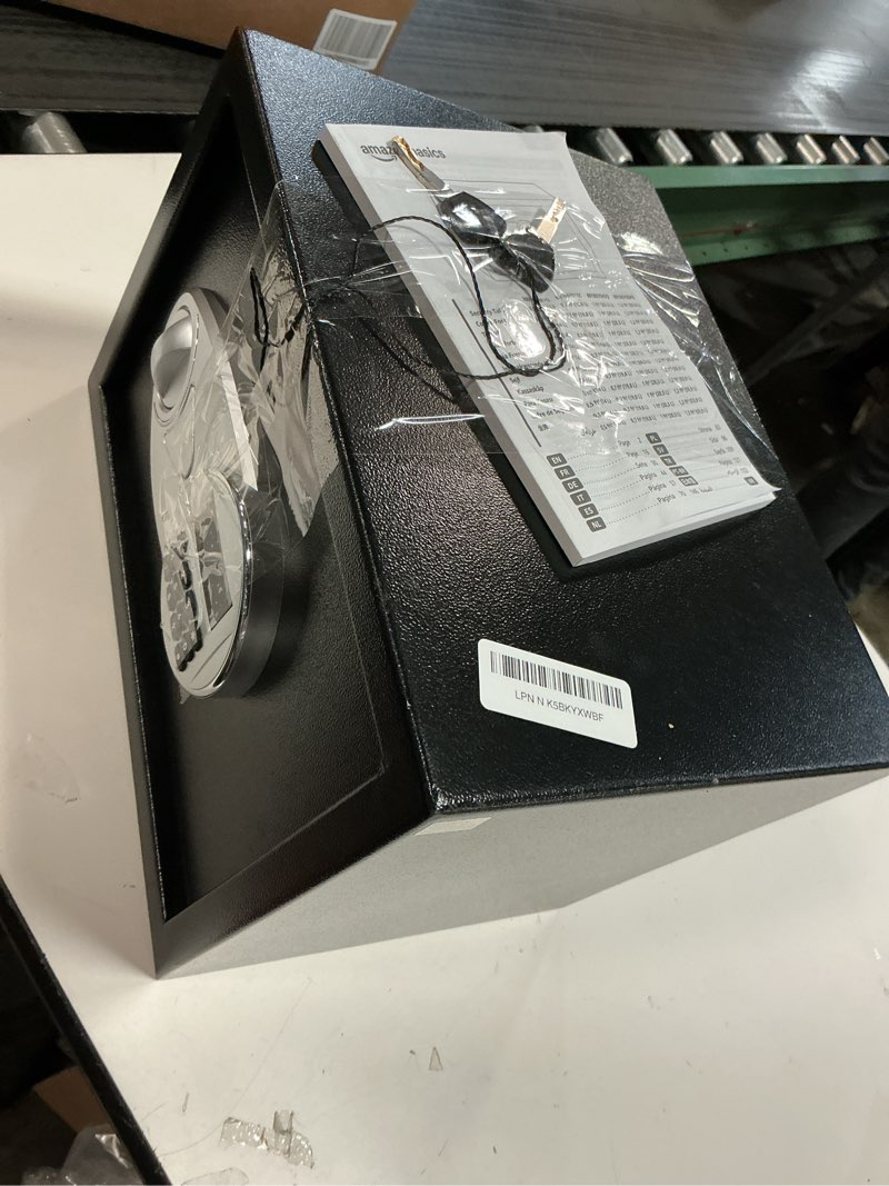 Condition photo showing As Is for Amazon Basics Steel Security Safe and Lock Box with Electronic Keypad, for Cash, Jewelry, Documents, Black, 0.5 Cubic Feet, 13.8" W x 9.8" D x 9.8" H