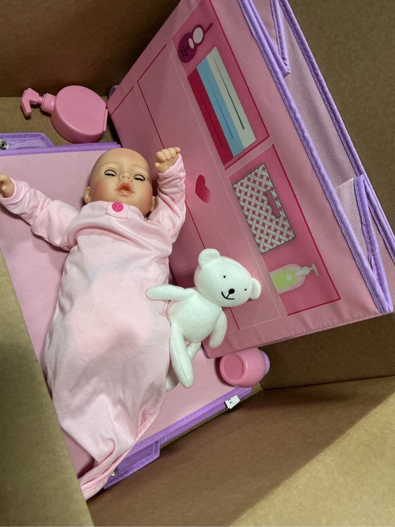 Condition photo showing As Is for adora realistic perfectly pink baby doll set with changing table and 10-piece accessories, includes storage box, diapers, and pacifier, gift for ages 3 and up