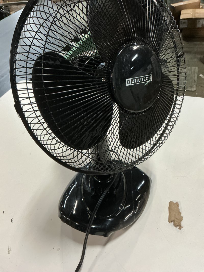 Condition photo showing As Is for utilitech 12-in indoor oscillating desk fan, in black
