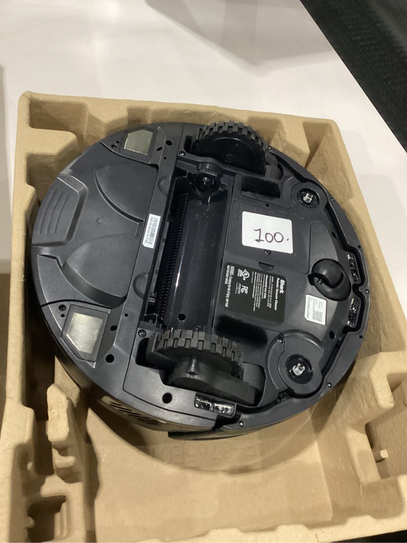 Condition photo showing As Is for VACUUM ONLY NO BASE NO BRUSH Shark AV753 ION Robot Vacuum, Tri-Brush System, Wifi Connected, 120 Min Runtime, Works with Alexa, Multi Surface Cleaning, Grey ION Robot (Grey)